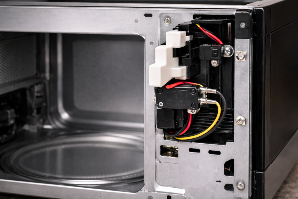 Microwave door latch area where the door switch assembly is installed.